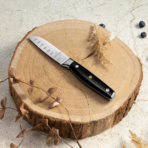 Product image of Santoku knife 9cm. Part of the Black Vantage Collection/Matte Black Collection/Black Silver Collection . Features: • Material: stainless steel • Size: 9 cm • Color: black- silver. (Studio view). Official Berlinger Haus product, boosted by Promintra sl.