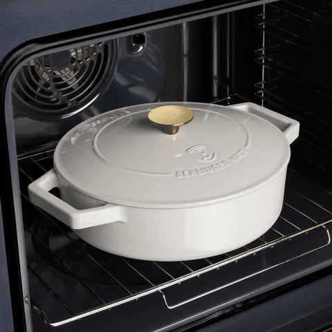 Product image of Shallow pot 26cm cast iron. Part of the Sahara Collection . Features: • Material: cast iron with 3 layers shiny ENAMEL coating • Size: Ø26*7,5 cm 2,57 L • Color: cream- white. (Studio view). Official Berlinger Haus product, boosted by Promintra sl.