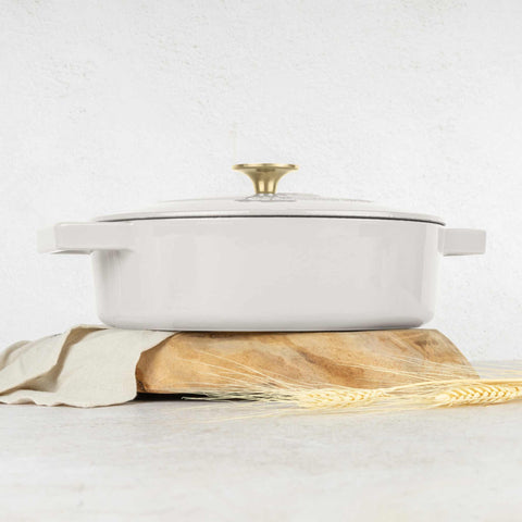 Product image of Shallow pot 26cm cast iron. Part of the Sahara Collection . Features: • Material: cast iron with 3 layers shiny ENAMEL coating • Size: Ø26*7,5 cm 2,57 L • Color: cream- white. (Studio view). Official Berlinger Haus product, boosted by Promintra sl.