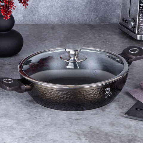 Product image of Shallow pot with lid 28cm. Part of the Primal Gloss Collection . Features: • Material: forged aluminum • Shallow pot with lid Ø28*7,5 cm 3,8L • Color: dark grey with black shadow and shining hammer effect REGISTERED DESIGN.... (Studio view). Official Berlinger Haus product, boosted by Promintra sl.