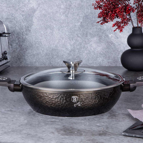 Product image of Shallow pot with lid 28cm. Part of the Primal Gloss Collection . Features: • Material: forged aluminum • Shallow pot with lid Ø28*7,5 cm 3,8L • Color: dark grey with black shadow and shining hammer effect REGISTERED DESIGN.... (Studio view). Official Berlinger Haus product, boosted by Promintra sl.