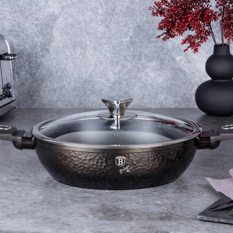 Product image of Shallow pot with lid 28cm. Part of the Primal Gloss Collection . Features: • Material: forged aluminum • Shallow pot with lid Ø28*7,5 cm 3,8L • Color: dark grey with black shadow and shining hammer effect REGISTERED DESIGN.... (Studio view). Official Berlinger Haus product, boosted by Promintra sl.