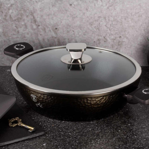 Product image of Shallow pot with lid 28cm. Part of the Primal Gloss Collection . Features: • Material: forged aluminum • Shallow pot with lid Ø28*7,5 cm 3,8L • Color: dark grey with black shadow and shining hammer effect REGISTERED DESIGN.... (Studio view). Official Berlinger Haus product, boosted by Promintra sl.