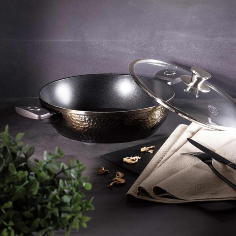 Product image of Shallow pot with lid 28cm. Part of the Primal Gloss Collection . Features: • Material: forged aluminum • Shallow pot with lid Ø28*7,5 cm 3,8L • Color: dark grey with black shadow and shining hammer effect REGISTERED DESIGN.... (Studio view). Official Berlinger Haus product, boosted by Promintra sl.