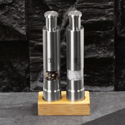 Product image of 2pcs salt and pepper mill set with bamboo stand. Part of the Black Vantage Collection/Matte Black Collection/Black Silver Collection/Eternal Collection . Features: • Material: 18/10 stainless steel with bamboo stand • Color: stainless steel. (Conceptual view). Official Berlinger Haus product, boosted by Promintra sl.