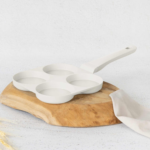 Product image of 4holes blank hamburger pan 20cm. Part of the Sahara Collection . Features: • Material: cast aluminium • Pancake pan Ø20*2,2 cm • Color: matt cream. (Studio view). Official Berlinger Haus product, boosted by Promintra sl.