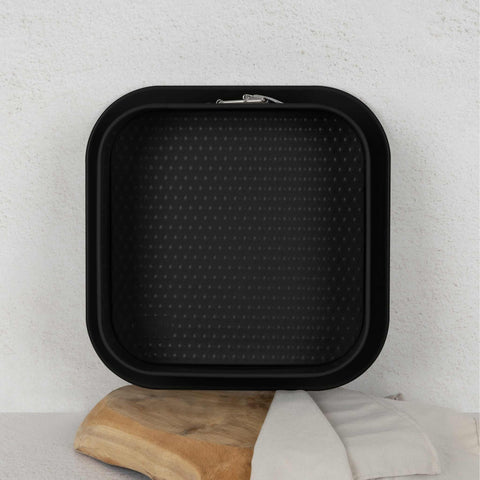 Product image of Square springform 28x28cm. Part of the Matte Black Collection/Black Rose Collection . Features: • Material: carbon steel with non-stick titanPro coating • Size: 23,8*23,8*8 cm • Base size: 28*28 cm • Color: matt black. (Studio view). Official Berlinger Haus product, boosted by Promintra sl.