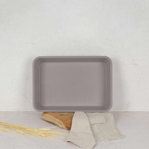 Product image of Oblong roaster 40x28cm. Part of the Taupe Collection . Features: • Material: carbon steel with non-stick titanPro coating • Size: 40*28*7 cm • Color: matt taupe. (Studio view). Official Berlinger Haus product, boosted by Promintra sl.