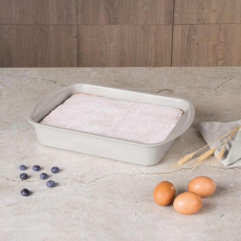 Product image of Oblong roaster 35x27cm. Part of the Sahara Collection . Features: • Material: carbon steel with titanPro non-stick coating • Size: 35*27*6,5 cm • Color: matt cream. (Lifestyle view). Official Berlinger Haus product, boosted by Promintra sl.