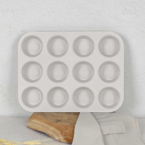 Product image of 12cups muffin pan. Part of the Sahara Collection . Features: • Material: carbon steel with titanPro non-stick coating • Size: 35*26,5*3 cm • Color: matt cream. (Studio view). Official Berlinger Haus product, boosted by Promintra sl.