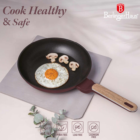 Product image of Frypan 24cm. Part of the Leonardo Nordic Collection . Features: • Material: forged aluminum with non-stick titanPro coating • Frypan Ø24*4,8 cm 1,7L • Color: matt bordeaux, wooden REGISTERED DESIGN BY BERLINGER .... (Studio view). Official Berlinger Haus product, boosted by Promintra sl.