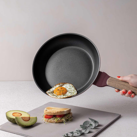 Product image of Frypan 24cm. Part of the Leonardo Nordic Collection . Features: • Material: forged aluminum with non-stick titanPro coating • Frypan Ø24*4,8 cm 1,7L • Color: matt bordeaux, wooden REGISTERED DESIGN BY BERLINGER .... (Studio view). Official Berlinger Haus product, boosted by Promintra sl.