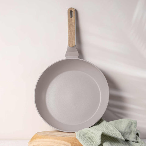Product image of Frypan 28cm. Part of the Taupe Nordic Collection . Features: • Material: forged aluminum with non-stick titanPro coating • Frypan Ø28*5,2 cm 2,4L • Color: matt taupe, wooden REGISTERED DESIGN BY BERLINGER HAUS!. (Studio view). Official Berlinger Haus product, boosted by Promintra sl.