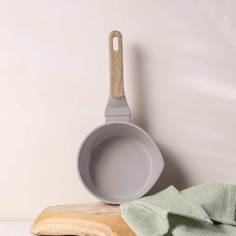 Product image of Sauce pan 16cm. Part of the Taupe Nordic Collection . Features: • Material: forged aluminum with non-stick titanPro coating • Sauce pan Ø16*7,5 cm 1,2L • Color: matt taupe, wooden REGISTERED DESIGN BY BERLINGER .... (Studio view). Official Berlinger Haus product, boosted by Promintra sl.
