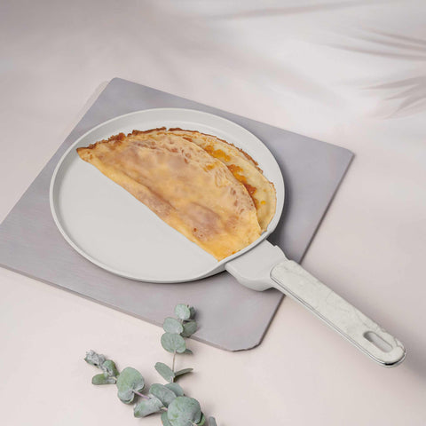 Product image of Pancake pan 25cm. Part of the Sahara Marble Collection . Features: • Material: forged aluminum with non-stick titanPro coating • Pancake pan Ø25*2,2 cm • Color: matt cream, marble REGISTERED DESIGN BY BERLINGER HAUS!. (Studio view). Official Berlinger Haus product, boosted by Promintra sl.