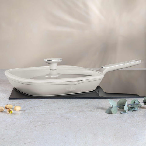 Product image of Grill pan with lid 28cm. Part of the Sahara Marble Collection . Features: • Material: forged aluminum with non-stick titanPro coating • Grill pan with lid Ø28*4,1 cm 2,1L • Color: matt cream, marble REGISTERED DESIGN BY B.... (Studio view). Official Berlinger Haus product, boosted by Promintra sl.