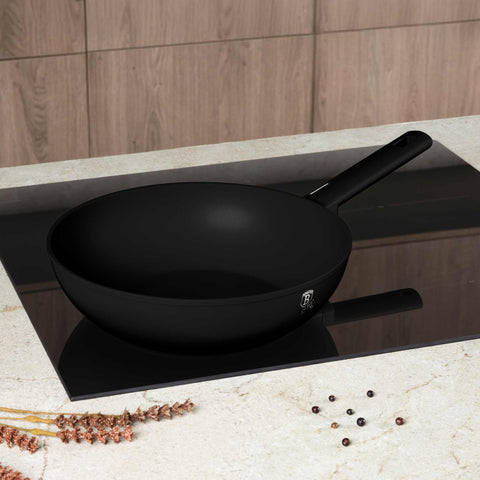 Product image of Wok 28cm. Part of the Matte Black Collection . Features: • Material: forged aluminum with non-stick titanPro coating • Wok Ø28*7,8 cm 3,1L • Color: black- silver. (Studio view). Official Berlinger Haus product, boosted by Promintra sl.