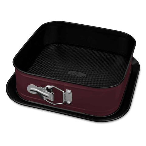 Product image of Square springform 28x28cm. Part of the Leonardo Collection . Features: • Material: carbon steel with non-stick titanPro coating • Size: 23,8*23,8*8 cm • Base size: 28*28 cm • Color: matt bordeaux. (Studio view). Official Berlinger Haus product, boosted by Promintra sl.