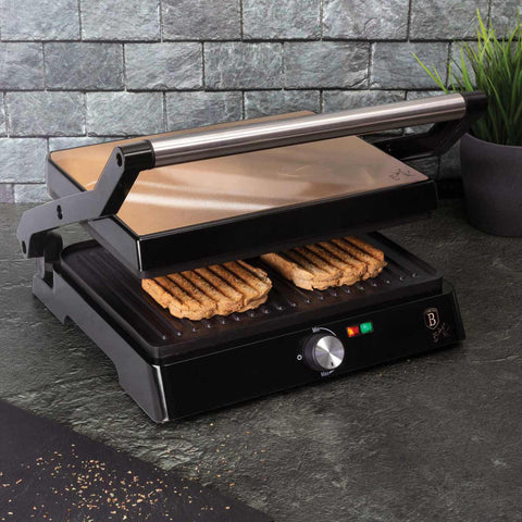 Product image of Electric grill with oil drip pan. Part of the Metallic Line Rose Gold Edition . Features: • Power: 2200W • Voltage: 220-240 V • NON-STICK coating on plate • Plate size: 29*23 cm • Color: rose gold • 2 IN 1 2 TYPES OF OPENING • Opening in.... (Studio view). Official Berlinger Haus product, boosted by Promintra sl.
