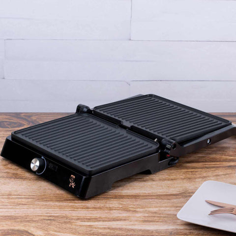 Product image of Electric grill with oil drip pan. Part of the Metallic Line Rose Gold Edition . Features: • Power: 2200W • Voltage: 220-240 V • NON-STICK coating on plate • Plate size: 29*23 cm • Color: rose gold • 2 IN 1 2 TYPES OF OPENING • Opening in.... (Studio view). Official Berlinger Haus product, boosted by Promintra sl.