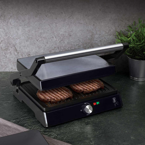 Product image of Electric grill with oil drip pan. Part of the Black Vantage Collection/Matte Black Collection/Black Silver Collection/Eternal Collection . Features: • Power: 2200W • Voltage: 220-240 V • NON-STICK coating on plate • Plate size: 29*23 cm • Color: stainless steel • 2 IN 1 2 TYPES OF OPENING. (Studio view). Official Berlinger Haus product, boosted by Promintra sl.