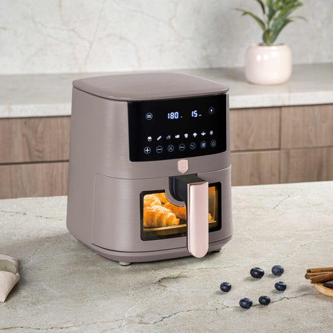 Product image of Air fryer 5L visible window. Part of the Taupe Collection . Features: • Power: 220-240V ~ 1400W • Temperature control: 40-200℃ • Include: • XL SIZE: food basket with non-stick coating 5L • DIGITAL • Color: matt taupe. (Studio view). Official Berlinger Haus product, boosted by Promintra sl.