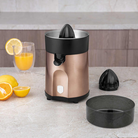 Product image of Juice extractor. Part of the Metallic Line Rose Gold Edition . Features: • Citrus juicer • Material: stainless steel • 85W • Juice cup 300 ml • 2 pcs squeezer attachments • Length of power cord: 80 cm • Color: rose gold. (Studio view). Official Berlinger Haus product, boosted by Promintra sl.