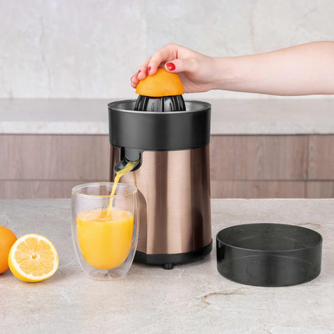 Product image of Juice extractor. Part of the Metallic Line Rose Gold Edition . Features: • Citrus juicer • Material: stainless steel • 85W • Juice cup 300 ml • 2 pcs squeezer attachments • Length of power cord: 80 cm • Color: rose gold. (Studio view). Official Berlinger Haus product, boosted by Promintra sl.