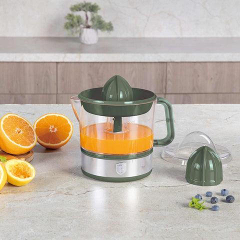 Product image of Electric citrus juicer. Part of the Matte Green Collection . Features: • Material: plastic, stainless steel • 220-240V/230VAC 50Hz 40W • Capacity: 0,7 L • Color: stainless steel- green. (Studio view). Official Berlinger Haus product, boosted by Promintra sl.