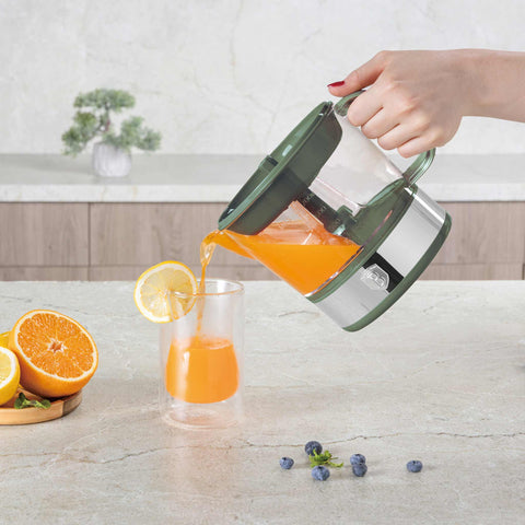 Product image of Electric citrus juicer. Part of the Matte Green Collection . Features: • Material: plastic, stainless steel • 220-240V/230VAC 50Hz 40W • Capacity: 0,7 L • Color: stainless steel- green. (Studio view). Official Berlinger Haus product, boosted by Promintra sl.