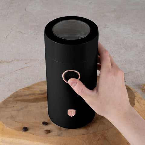 Product image of Electric coffee grinder. Part of the Black Rose Collection . Features: • Power: 150 W • 220V-240V 50/60 Hz • Stainless steel bowl • Stainless steel blades • Color: black- rose gold. (Conceptual view). Official Berlinger Haus product, boosted by Promintra sl.