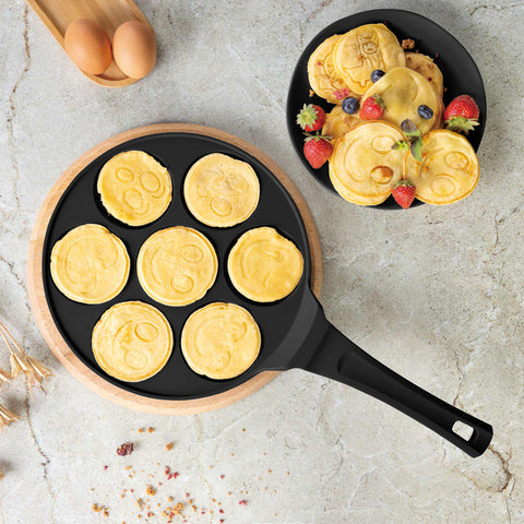 Product image of 7holes emoji pancake pan 26cm. Part of the Matte Black Collection/Black Rose Collection . Features: • Material: cast aluminium • Pancake pan Ø26*1,3 cm • Color: matt black. (Studio view). Official Berlinger Haus product, boosted by Promintra sl.