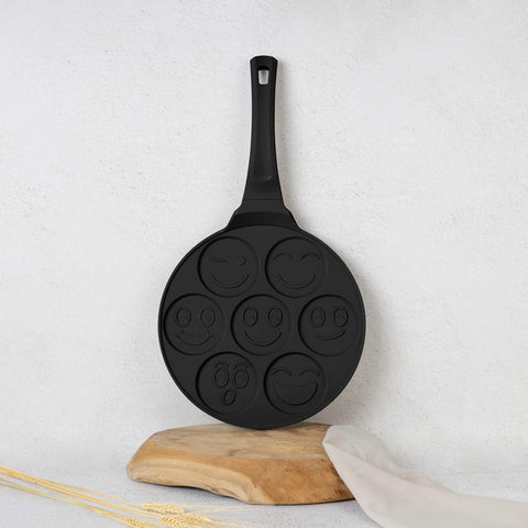 Product image of 7holes emoji pancake pan 26cm. Part of the Matte Black Collection/Black Rose Collection . Features: • Material: cast aluminium • Pancake pan Ø26*1,3 cm • Color: matt black. (Studio view). Official Berlinger Haus product, boosted by Promintra sl.