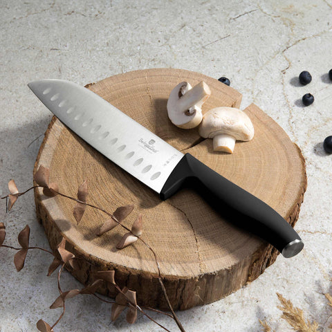Product image of Santoku knife 17,5cm. Part of the Black Vantage Collection/Matte Black Collection/Black Silver Collection . Features: • Material: stainless steel • Size: 17,5 cm • Color: black- silver REGISTERED DESIGN BY BERLINGER HAUS!. (Studio view). Official Berlinger Haus product, boosted by Promintra sl.