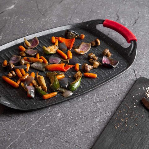 Product image of Grill plate 47cm. Part of the Metallic Line Burgundy Edition . Features: • Material: forged aluminum • Size: 47*29 cm • Color: black- burgundy • FREE 2 PCS HEAT RESISTANT SILICONE HANDLE. (Studio view). Official Berlinger Haus product, boosted by Promintra sl.