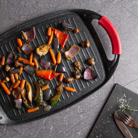 Product image of Grill plate 47cm. Part of the Metallic Line Burgundy Edition . Features: • Material: forged aluminum • Size: 47*29 cm • Color: black- burgundy • FREE 2 PCS HEAT RESISTANT SILICONE HANDLE. (Studio view). Official Berlinger Haus product, boosted by Promintra sl.
