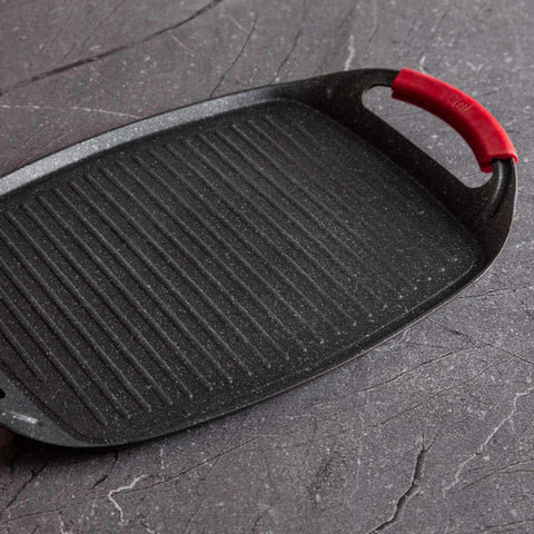 Product image of Grill plate 47cm. Part of the Metallic Line Burgundy Edition . Features: • Material: forged aluminum • Size: 47*29 cm • Color: black- burgundy • FREE 2 PCS HEAT RESISTANT SILICONE HANDLE. (Studio view). Official Berlinger Haus product, boosted by Promintra sl.