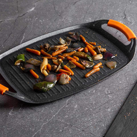 Product image of Grill plate 47cm. Part of the Granit Diamond Line . Features: • Material: aluminum • Size: 47*29 cm • Color: black/ orange • FREE 2 PCS HEAT RESISTANT SILICONE HANDLE. (Studio view). Official Berlinger Haus product, boosted by Promintra sl.