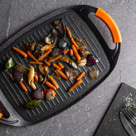 Product image of Grill plate 47cm. Part of the Granit Diamond Line . Features: • Material: aluminum • Size: 47*29 cm • Color: black/ orange • FREE 2 PCS HEAT RESISTANT SILICONE HANDLE. (Studio view). Official Berlinger Haus product, boosted by Promintra sl.