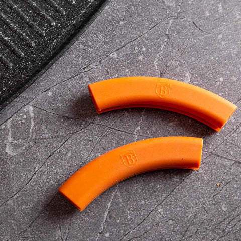 Product image of Grill plate 47cm. Part of the Granit Diamond Line . Features: • Material: aluminum • Size: 47*29 cm • Color: black/ orange • FREE 2 PCS HEAT RESISTANT SILICONE HANDLE. (Studio view). Official Berlinger Haus product, boosted by Promintra sl.