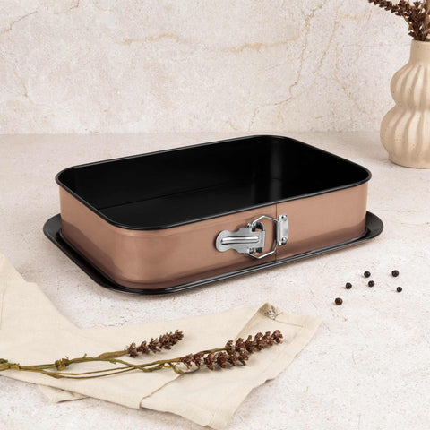 Product image of Rectangle springform 39x27cm. Part of the Metallic Line Rose Gold Edition . Features: • Material: carbon steel with titan non-stick coating • Size: 35*23*6,5 cm • Base size: 39*27 cm • Color: metallic rose gold. (Studio view). Official Berlinger Haus product, boosted by Promintra sl.