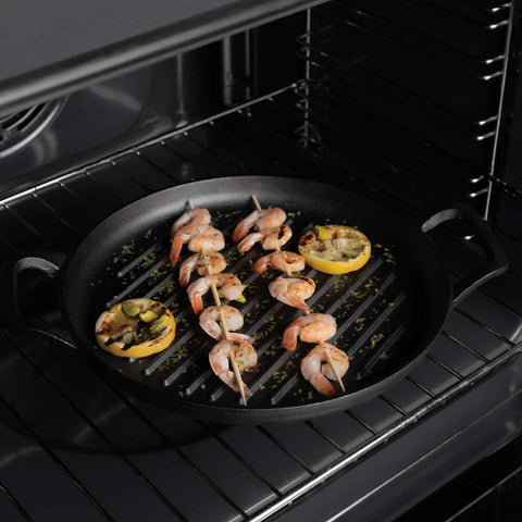 Product image of Round grill plate 33cm cast iron. Part of the Strong Mold Seria . Features: • Material: cast iron with outside/inside oil coating • Size: 32,9*25*2,5 cm 1,95 kg • Color: black. (Studio view). Official Berlinger Haus product, boosted by Promintra sl.