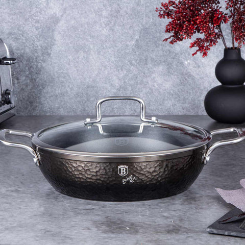 Product image of Shallow pot with lid 28cm. Part of the Shine Basalt Collection . Features: • Material: forged aluminum • Shallow pot with lid Ø28*7,5 cm 3,8L • Color: black with shining hammer effect REGISTERED DESIGN BY BERLINGER HAUS!. (Studio view). Official Berlinger Haus product, boosted by Promintra sl.