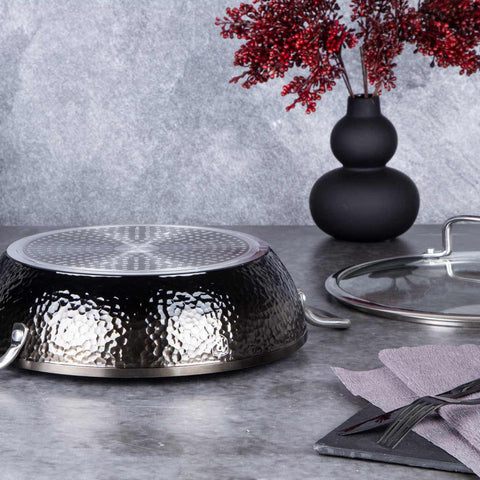 Product image of Shallow pot with lid 28cm. Part of the Shine Basalt Collection . Features: • Material: forged aluminum • Shallow pot with lid Ø28*7,5 cm 3,8L • Color: black with shining hammer effect REGISTERED DESIGN BY BERLINGER HAUS!. (Studio view). Official Berlinger Haus product, boosted by Promintra sl.