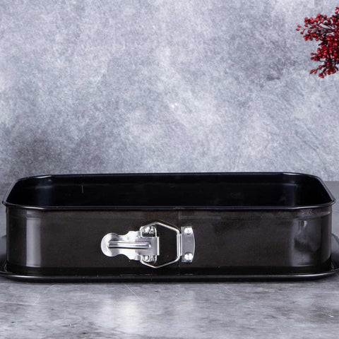 Product image of Rectangle springform 39x27cm. Part of the Metallic Line Shiny Black Edition . Features: • Material: carbon steel with titan non-stick coating • Size: 35*23*6,5 cm • Base size: 39*27 cm • Color: metallic black. (Studio view). Official Berlinger Haus product, boosted by Promintra sl.