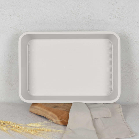 Product image of Oblong roaster 40x28cm. Part of the Sahara Collection . Features: • Material: carbon steel with non-stick titanPro coating • Size: 40*28*7 cm • Color: matt cream. (Studio view). Official Berlinger Haus product, boosted by Promintra sl.