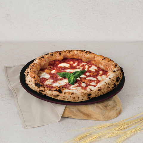 Product image of Pizza pan 32cm. Part of the Leonardo Collection . Features: • Material: carbon steel with titanPro non-stick coating • Size: 32*1,1 cm • Color: matt bordeaux. (Studio view). Official Berlinger Haus product, boosted by Promintra sl.