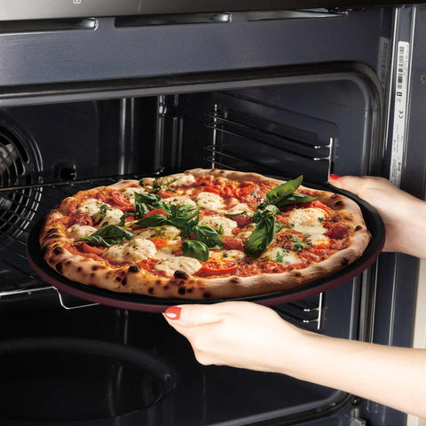 Product image of Pizza pan 32cm. Part of the Leonardo Collection . Features: • Material: carbon steel with titanPro non-stick coating • Size: 32*1,1 cm • Color: matt bordeaux. (Studio view). Official Berlinger Haus product, boosted by Promintra sl.