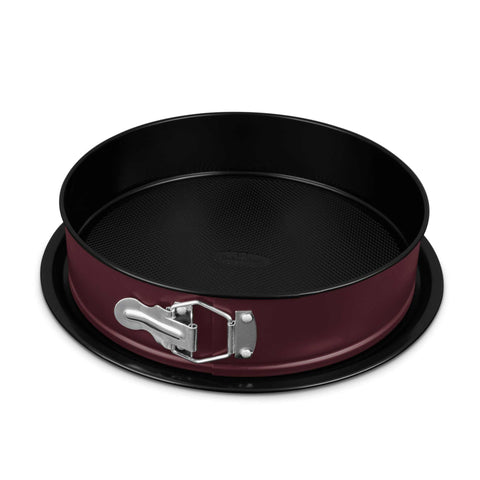 Product image of Round springform 26x6,8cm. Part of the Leonardo Collection . Features: • Material: carbon steel with titanPro non-stick coating • Size: 26*6,8 cm • Base size: Ø29,9 cm • Color: matt bordeaux. (Studio view). Official Berlinger Haus product, boosted by Promintra sl.