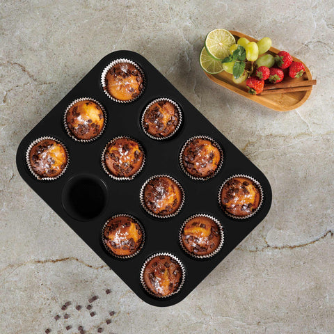 Product image of 12cups muffin pan. Part of the Matte Green Collection . Features: • Material: carbon steel with titanPro non-stick coating • Size: 35*26,5*3 cm • Color: matt green. (Studio view). Official Berlinger Haus product, boosted by Promintra sl.